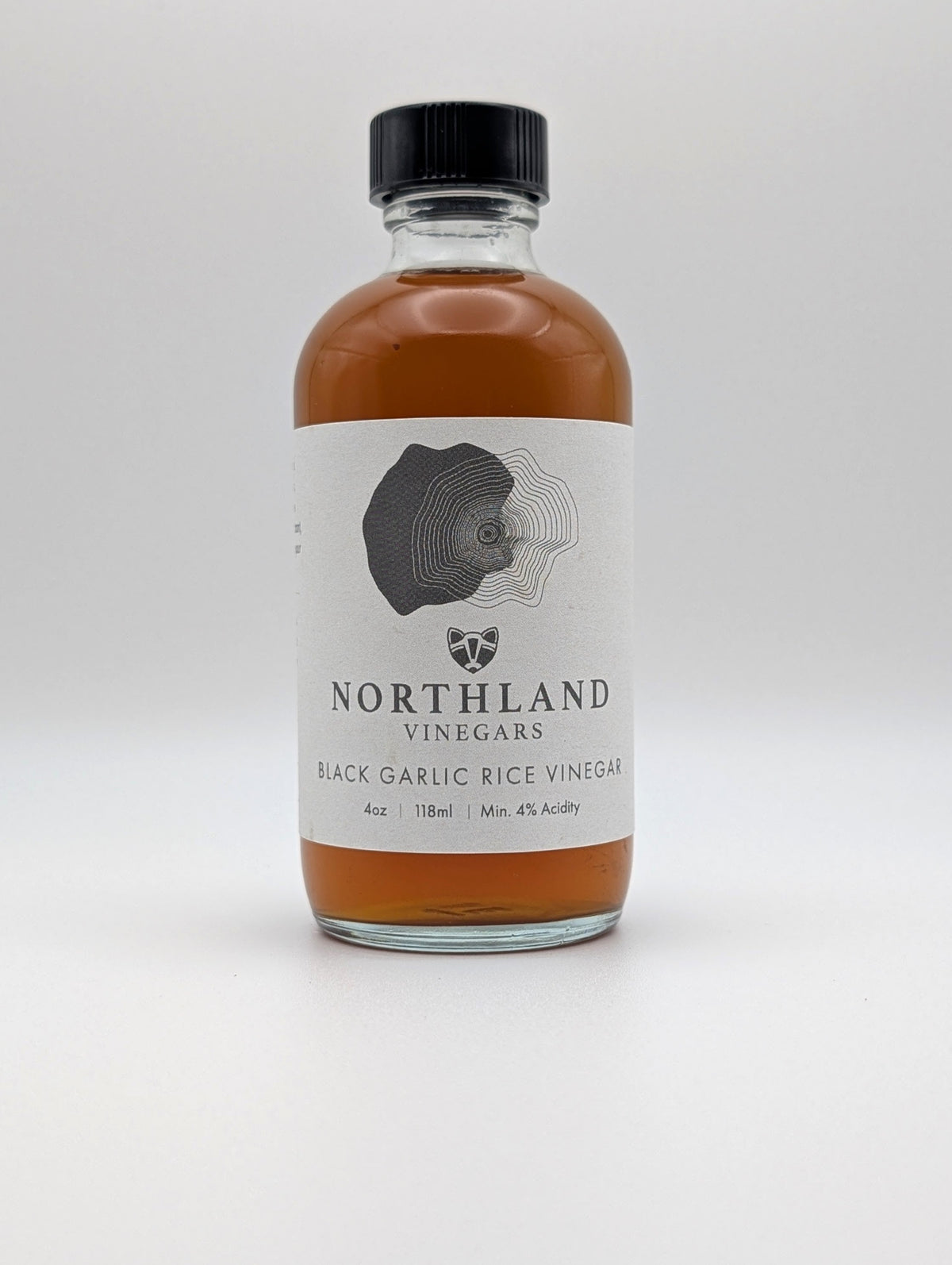 Bottle of Northland Vinegars black garlic rice vinegar on a white background