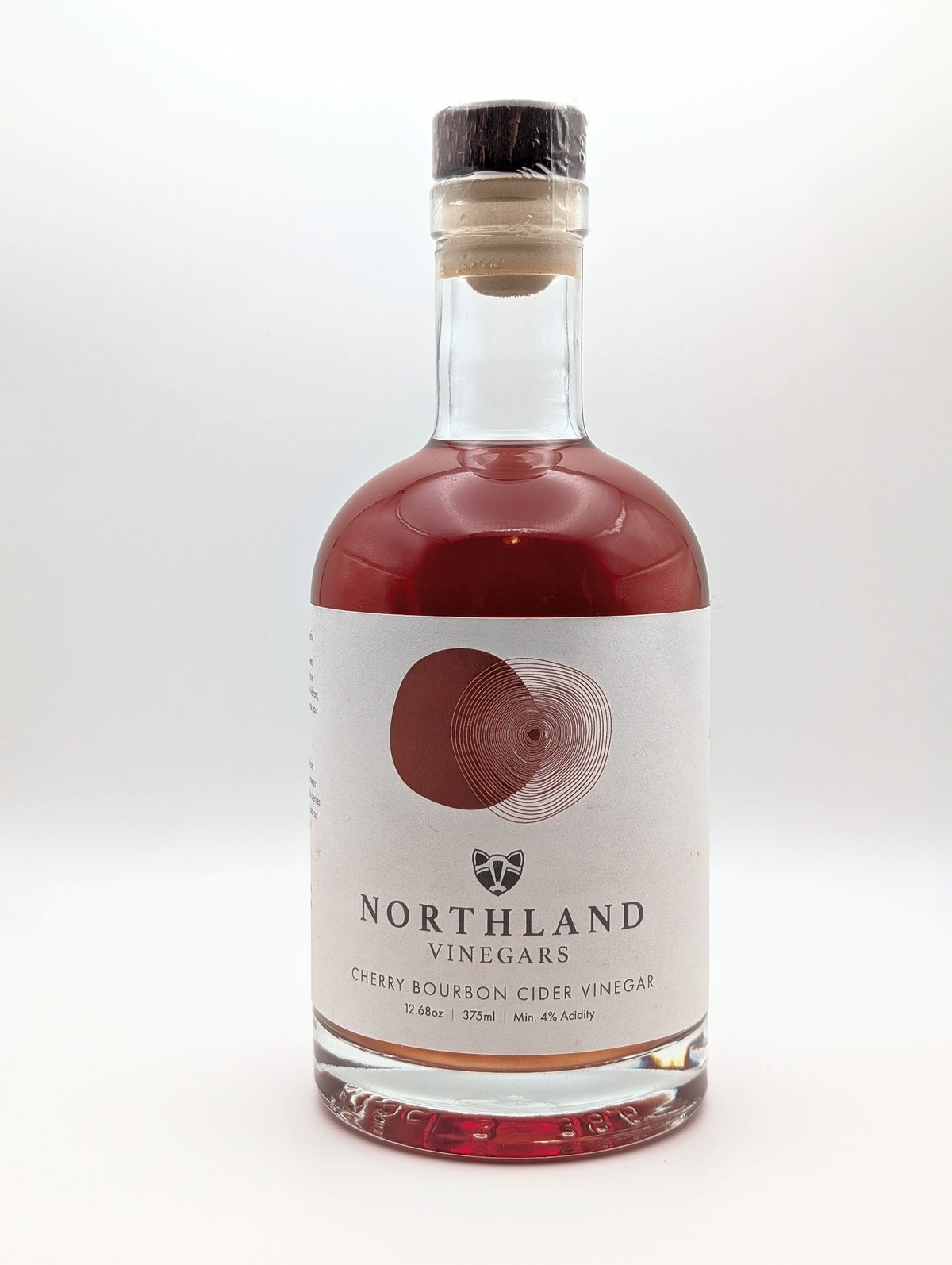 Bottle of Northland Vinegars Cherry Bourbon Cider Vinegar on a white background