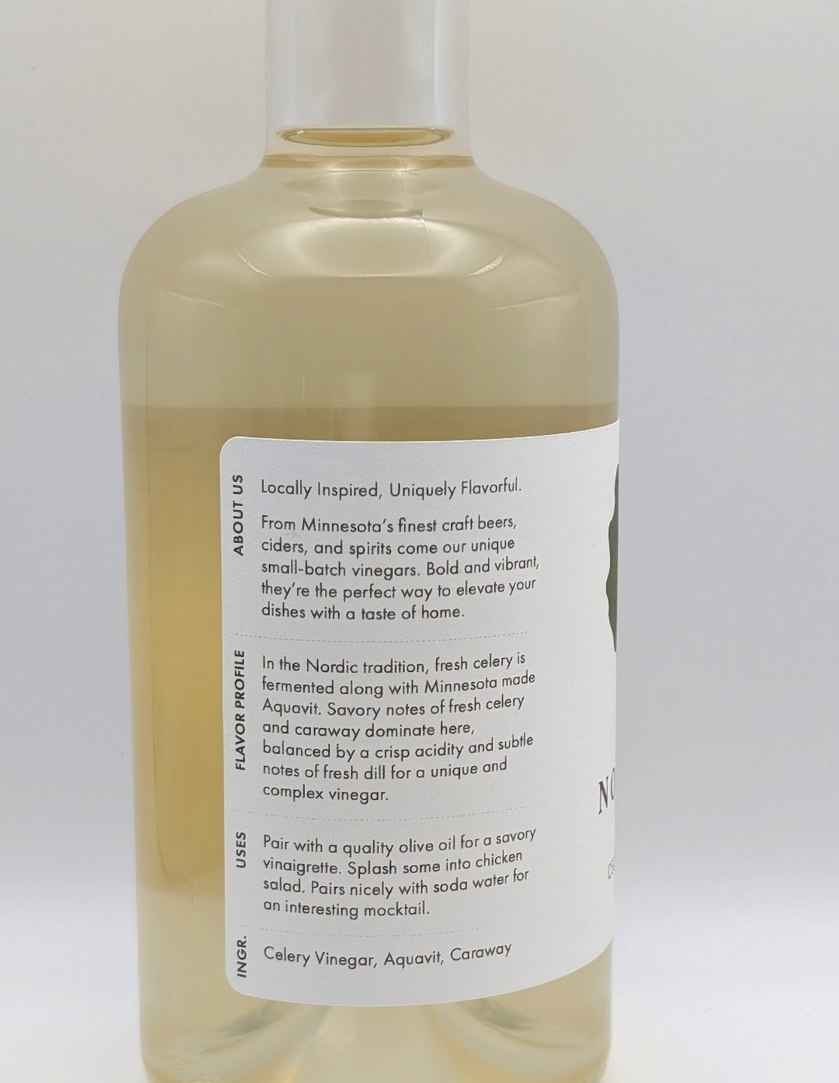 Bottle of Celery Aquavit Vinegar with fresh celery and caraway notes, handcrafted in Minnesota.